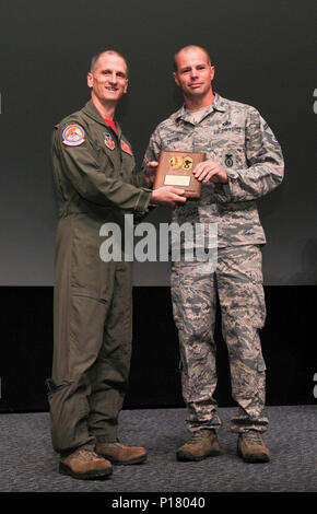 The commander of the 187th Fighter Wing presents the Outstanding Airman ...