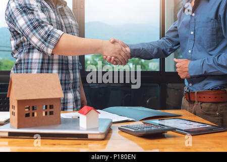 Real estate agent shaking hands with his client after sealing deal. Stock Photo