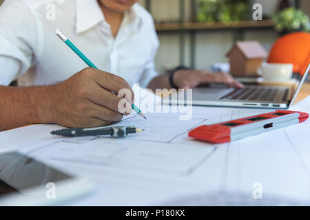 Engineer and Architect concept, Engineer Architects and real estate agent office team working with blueprints Stock Photo