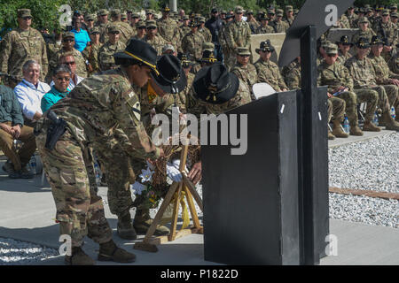 From left: Command Sgt. Maj. Jill L. Crosby, Warrant Officer 2 Samuel Gabara and Col. Christopher H. Colavita place a wreath at the 1st Cavalry Division Resolute Support Sustainment Brigade Memorial which was dedicated May 7 at Bagram Airfield (BAF), Afghanistan. Staff Sgt. John W. Perry, Pfc. Tyler R. Iubelt, Col. (Ret.) Jarrold M. Reeves and Dr. Peter L. Provost were killed by a suicide bomber at BAF on Nov. 12, 2016. Sgt. 1st Class Allan E. Brown died of his wounds Dec. 6, 2016. Stock Photo