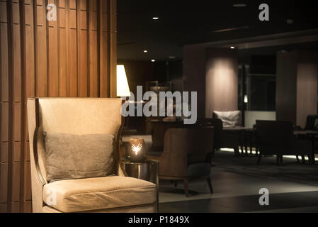 Luxury sofas in the hotel's guest lounge with night lighting. Stock Photo