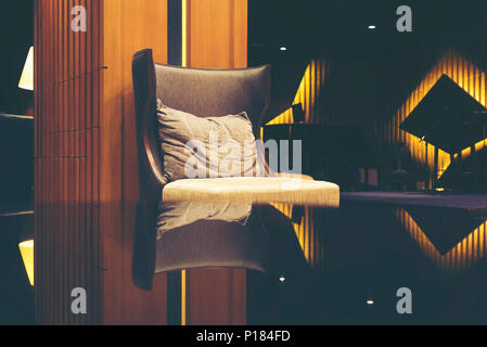 Luxury sofas in the hotel's guest lounge with night lighting. Stock Photo