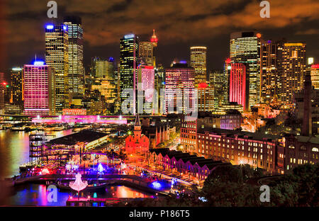 Sydney city CBD towers on Circular quay waterfront of Sydney harbour with bright colourful illumination during annual Vivid sydney light show and fest Stock Photo