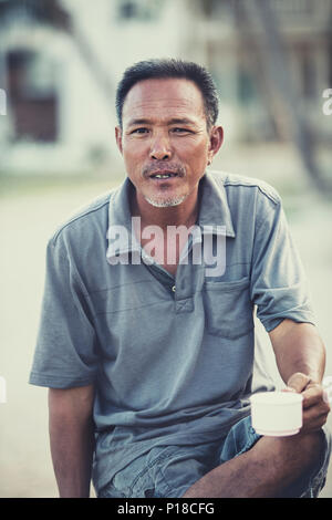 asian senior man and coffee cup in hand Stock Photo