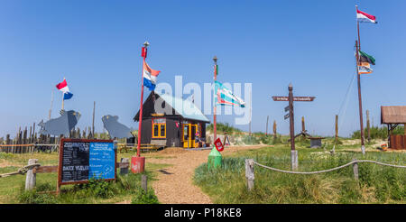 Panorama of flags and a little wooden cottage on Texel island in The Netherlands Stock Photo