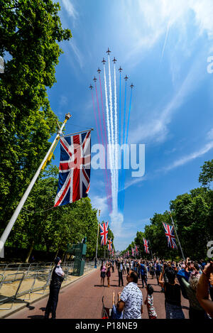 British Red Arrows of the Royal Air Force flying down The Mall for Queen's Birthday Flypast over London after Trooping the Colour 2018. People watch Stock Photo