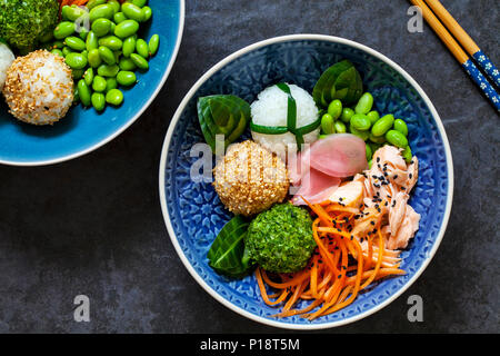 Japanese onigiri sushi rice balls with salmon and soy beans Stock Photo