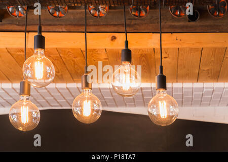 Decorative antique LED tungsten light bulbs hanging on ceiling. Stock Photo