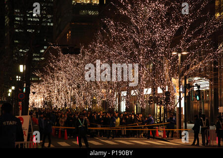 Tokyo, Japan - December 28, 2017: Japanese people and tourists waiting in line to enter Marunouchi Illumination 2017  at the main street, Marunouchi N Stock Photo