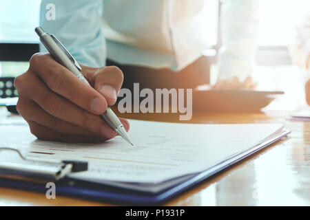 Businessman writing or pointing on report paper. Business strategy concept. Stock Photo
