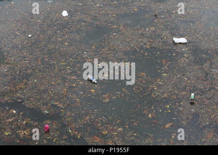 Styrofoam packet, bottle containers and plastic floating on the water causing unnecessary water pollution on earth. Stock Photo