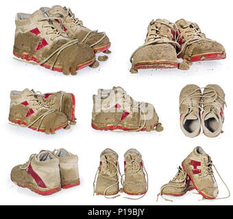 Children's tiny shoes covered with mud. Dirty leggings for children's feet in raspberry and white color isolated on a white background. Stock Photo