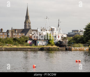 Dublin, Ireland - September 17, 2016: The derelict ferry boat Naomh Eanna docked in Dublin's Grand Canal Dock.