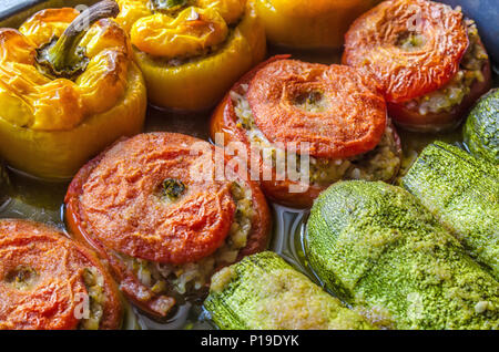 Greek traditional food Gemista already cooked in the oven. Stuffed  peppers, tomatoes, zucchini with rice, vegetables, herbs and sometimes minced meat Stock Photo