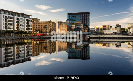 Dublin, Ireland - September 18, 2016: Apartment buildings, office blocks and warehouses are reflected in the Grand Union Dock in Dublin's redeveloped  Stock Photo