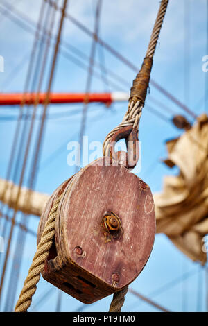 Close up picture of an old sailing ship wooden pulley, selective focus. Stock Photo