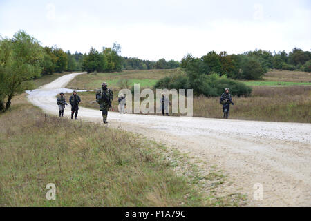 Italian soldiers patrol along a trail while role-playing as opposing force during Exercise Allied Spirit V at 7th Army Training Command's Hohenfels Training Area, Germany, Oct. 6, 2016. Exercise Allied Spirit includes about 2,520 participants from eight NATO nations, and exercises tactical interoperability and tests secure communications within Alliance members and partner nations.(U.S. Army photo by Visual Information Specialist Gerhard Seuffert) Stock Photo