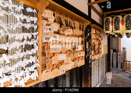 Ema Wooden Prayer Plaques and O-mikuji Paper Fortunes at the Hozenji Temple in Osaka, Japan Stock Photo