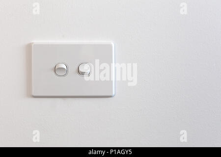 Modern double light switch on white wall with copy space Stock Photo