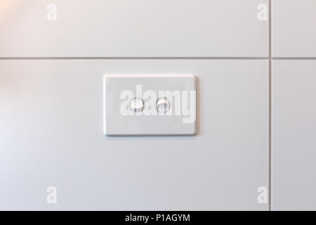 Modern double light switch on white tiles wall with copy space Stock Photo