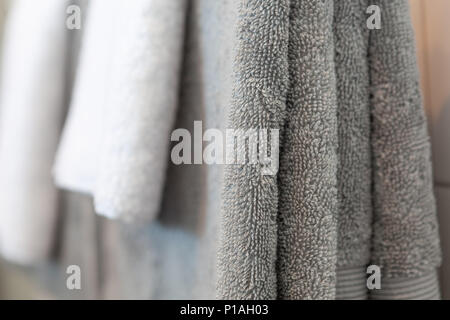 Close-up of folded hanging shower towels - focus on foreground Stock Photo