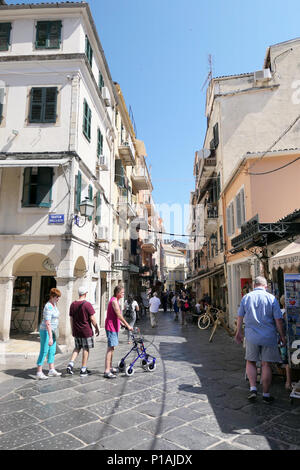 Corfu City, Corfu/ GREECE June 01 2018: Cityscape of Corfu town (Kerkyra) with people walking through historical small streets with stores, bars and r Stock Photo