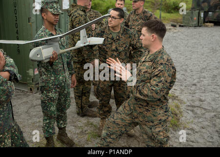 U.S. Marine Corps Cpl. Justin Fernandes teaches Philippine Marines about the RQ-11 Raven during Philippine Amphibious Landing Exercise 33 (PHIBLEX) on Colonel Ernesto Ravina Air Base, Philippines, Oct. 7, 2016. PHIBLEX is an annual U.S.-Philippine military bilateral exercise that combines amphibious capabilities and live-fire training with humanitarian civic assistance efforts to strengthen interoperability and working relationships. Fernandes, from St. Louis, Mo., is an intelligence analyst with 2nd Battalion, 4th Marine Regiment, Headquarters and Support Company.  The Philippine Marines are  Stock Photo