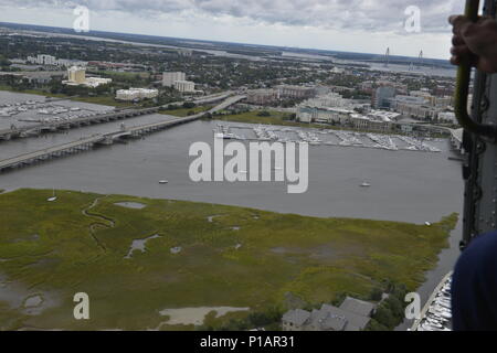 A MH-60 helicopter crew from Coast Guard Aviation Training Center Mobile conducted a fly over of the Charleston, South Carolina area that was affected by Hurricane Matthew, October 8, 2016. The Coast Guard is committed to the safety of the community, environment, and responders. Stock Photo