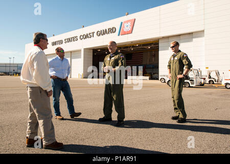 Congressman Buddy Carter discusses operations with Cmdr. J. Marshall Branch at Air Station Savannah Oct. 9, 2016. Coast Guard crews are utilizing Hunter Army Airfield as a forward operating base for Hurricane Matthew response efforts. U.S. Coast Guard photo by Petty Officer 2nd Class Christopher M. Yaw/PADET Jacksonville D7 External Affairs Stock Photo