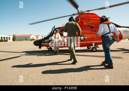 Congressman Buddy Carter walks toward an MH-65 Dolphin helicopter at Air Station Savannah for a damage assessment flight Oct. 9, 2016. Coast Guard crews are utilizing Hunter Army Airfield as a forward operating base for Hurricane Matthew response efforts. U.S. Coast Guard photo by Petty Officer 2nd Class Christopher M. Yaw/PADET Jacksonville D7 External Affairs Stock Photo