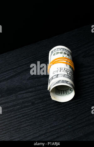 Rolled banknotes of 100 dollars isolated on white background with ...