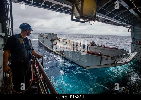 161008-N-XM324-077SOUTH CHINA SEA (Oct. 8, 2016) U.S. Navy Petty Officer 3rd Class David Coburn stands by as Landing Craft, Utility 1634, assigned to Naval Beach Unit (NBU) 7, embarks the well deck of the amphibious transport dock ship USS Green Bay (LPD 20) during Philippine Landing Exercise 33 (PHIBLEX). PHIBLEX 33 is an annual U.S.-Philippine bilateral exercise that combines amphibious landing and live-fire training with humanitarian civic assistance efforts to strengthen interoperability and working relationships. (U.S. Navy photo by Petty Officer 3rd Class Patrick Dionne/Released)