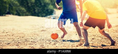 playing beach soccer Stock Photo