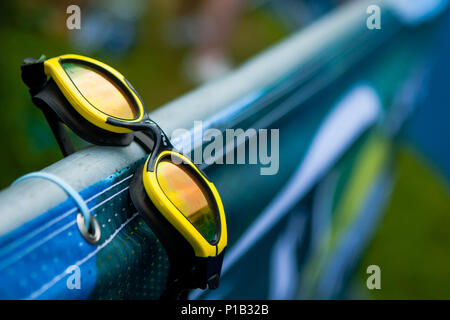 Abandoned swimming googles left on a fence at the Great North Swim, Lake Windermere, UK. Stock Photo