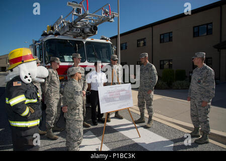 Col. Ethan Griffin, 436th Airlift Wing commander, thanks members of the 436th Civil Engineer Squadron Fire Department for their efforts to make Fire Prevention Week a success Oct. 6, 2016, at Dover Air Force Base, Del. The unit’s firefighters volunteer their time to host public events while their on-the-clock wingmen keep the installation safe. (U.S. Air Force photo by Senior Airman Aaron J. Jenne) Stock Photo