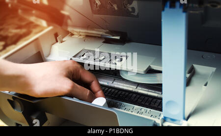 a man is repairing a printer. digital photocopier machine Stock Photo