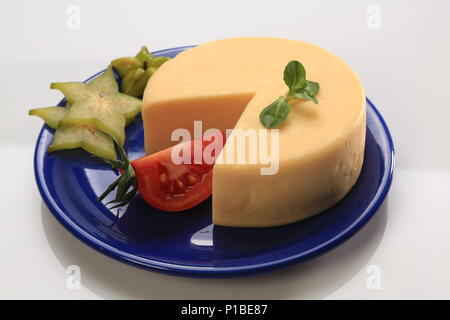 A sliced cheese wheel Stock Photo