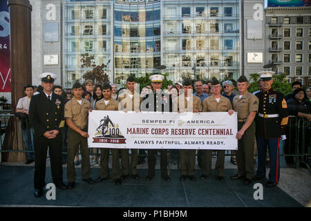 Marines pose with the leaders of Marine Forces Reserve and Marine Forces North, Command Master Chief Christopher D. Kotz (left), Lt. Gen. Rex C. McMillian (center), and Sgt. Maj. Patrick L. Kimble (right), during a ceremony for San Francisco’s 36th annual Fleet Week, at Union Square, Oct. 8, 2016. This year’s Fleet Week commemorated the Marine Corps Reserve Centennial, which celebrates the heritage and contributions of reserve Marines, past and present. Stock Photo