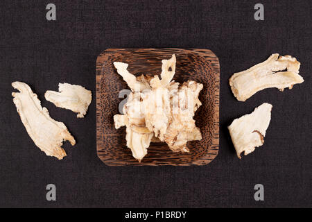 Angelica root used in chinese traditional herbal medicine over black background. Radix angelicae sinensis, Dang gui. Stock Photo