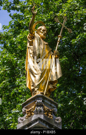 A golden statue of Saint Paul on St. Pauls Cross located in the churchyard of St. Pauls Cathedral in London, UK. Stock Photo