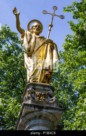 A golden statue of Saint Paul on St. Pauls Cross located in the churchyard of St. Pauls Cathedral in London, UK. Stock Photo