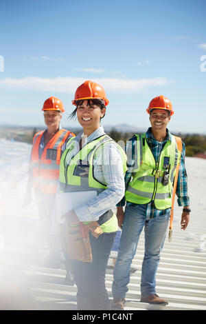 Portrait smiling, confident engineers at sunny power plant Stock Photo