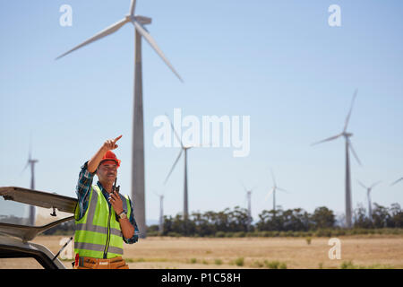 Engineer with walkie-talkie at wind turbine power plant Stock Photo