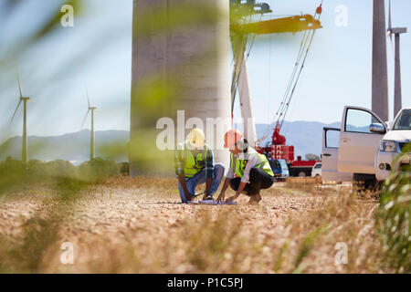 Engineers reviewing plans at turbine power plant Stock Photo