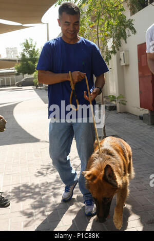 161006-M-PJ210-050 DUBAI, United Arab Emirates (Oct. 6, 2016) Maj. Darryl Lamberth, Marine commander of troops for the amphibious dock landing ship USS Whidbey Island (LSD 41), walks a dog during a community relations event in Dubai, Oct. 6, 2016. 22nd MEU, deployed with the Wasp Amphibious Ready Group, is maintaining regional security in the U.S. 5th Fleet area of operations. (U.S. Marine Corps photo by Cpl. Chris Garcia)