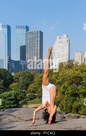 A young woman doing yoga in Central Park, New York City. Stock Photo