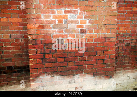 water damage lines including brick efflorescence in old historic building built over a stream avebury wiltshire england uk Stock Photo