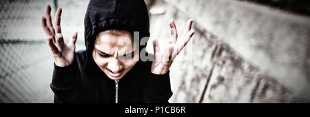 Angry teenage girl standing at school campus Stock Photo
