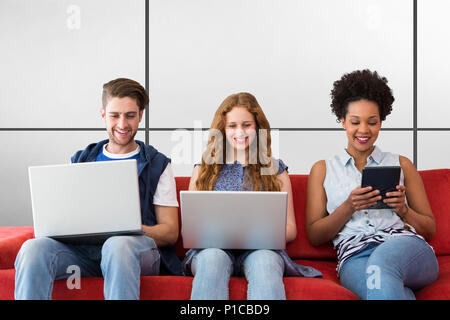 Composite image of creative team using laptops and digital tablet Stock Photo