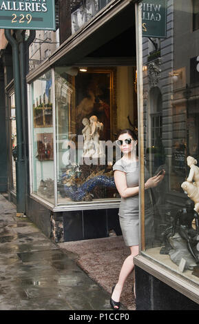 A young woman antique shopping on Royal street in New Orleans, Louisiana Stock Photo